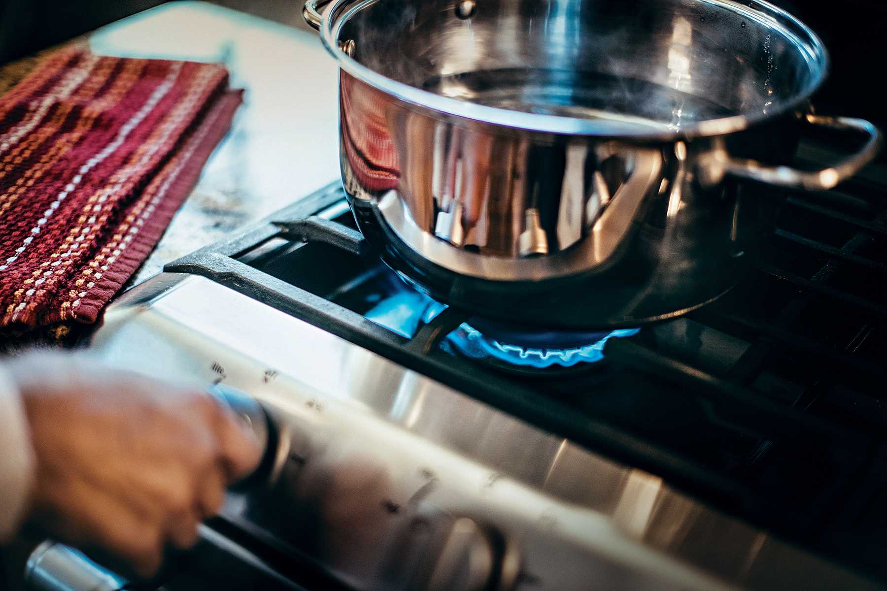 Turning on the propane stove to cook | PERC