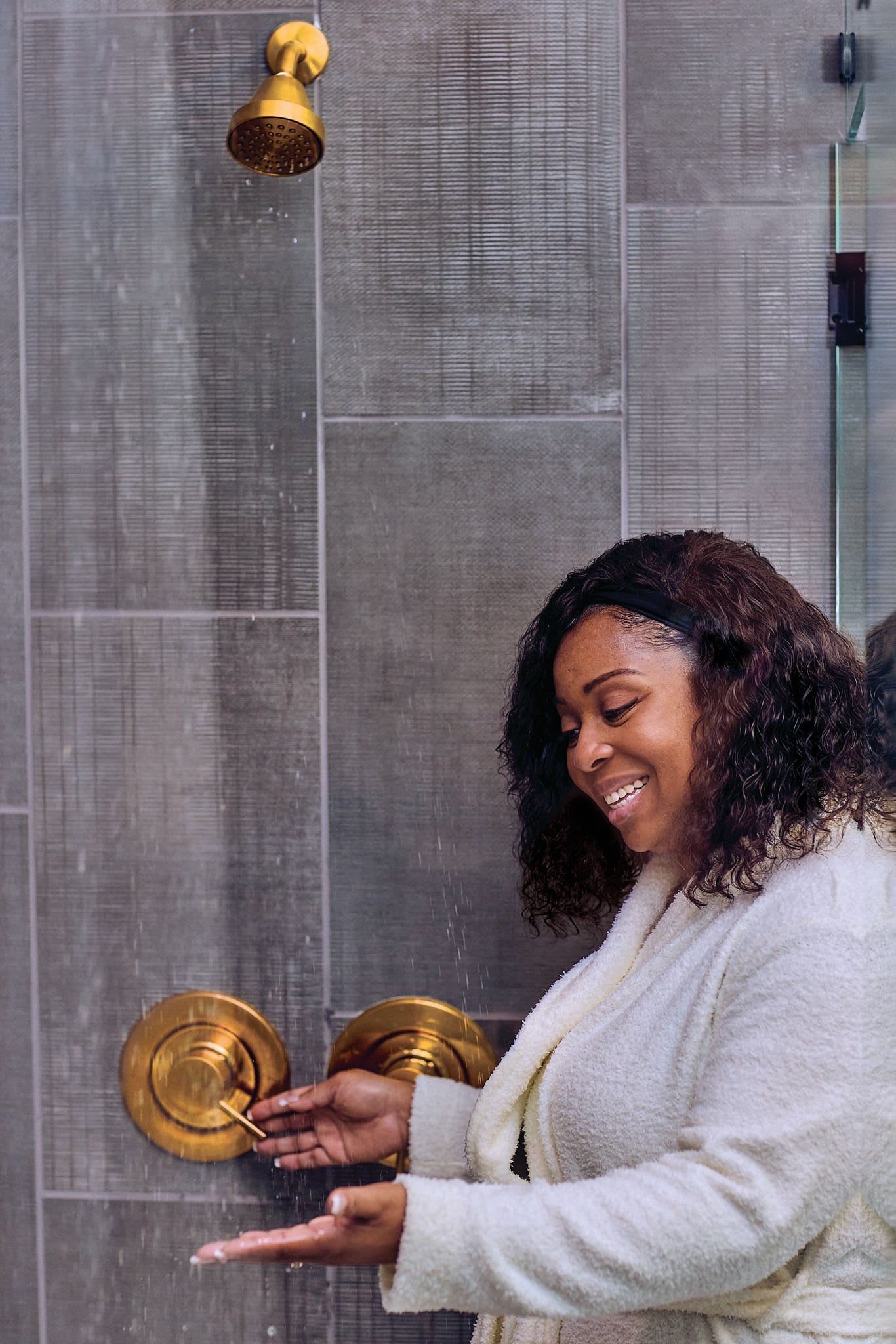 Woman Checking Water Temperature in Shower | PERC
