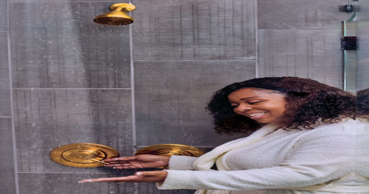 Woman Checking Water Temperature in Shower | PERC